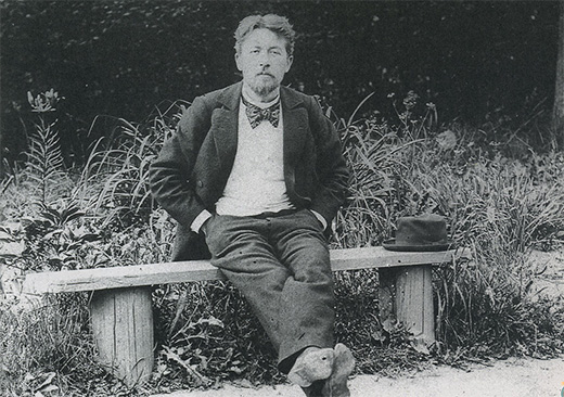Anton Chekhov seated on a bench. SCRSS - Society for Cooperation in Russian And Soviet Studies.